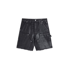 Gallery Dept Denim Shorts Black waxed-finish work pants featuring paneled denim detailing at the knees—a versatile, high-street style piece.