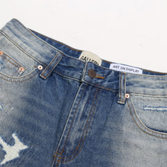 Gallery Dept Denim Shorts Distressed denim shorts with patches, rips, and frayed hems—casual style.